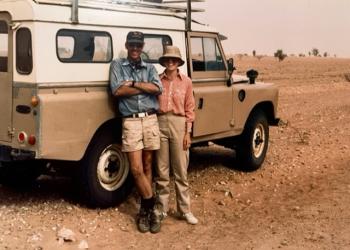 Drs. David and Dorinda Dallmeyer in front of a land rover in the Sahara Desert